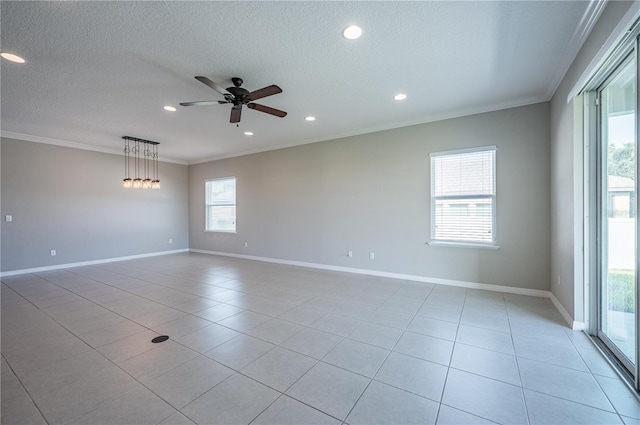 tiled empty room with a textured ceiling, ceiling fan, and crown molding