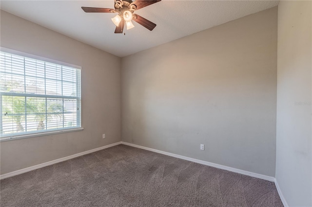 unfurnished room with ceiling fan and carpet floors