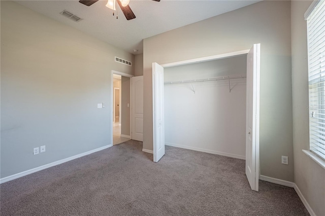 unfurnished bedroom with ceiling fan, light colored carpet, and a closet