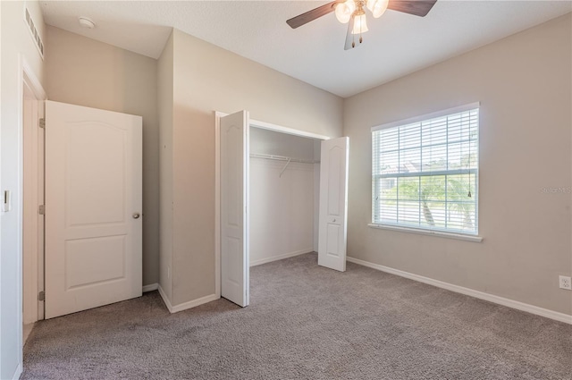 unfurnished bedroom featuring a closet, ceiling fan, and light colored carpet