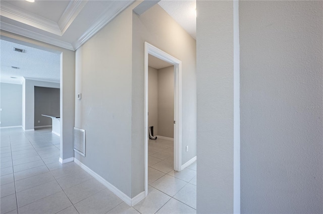 corridor featuring crown molding and light tile patterned flooring