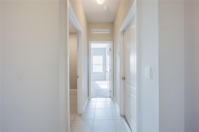 hall featuring light tile patterned floors