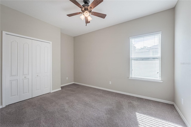 unfurnished bedroom with ceiling fan, a closet, and light carpet