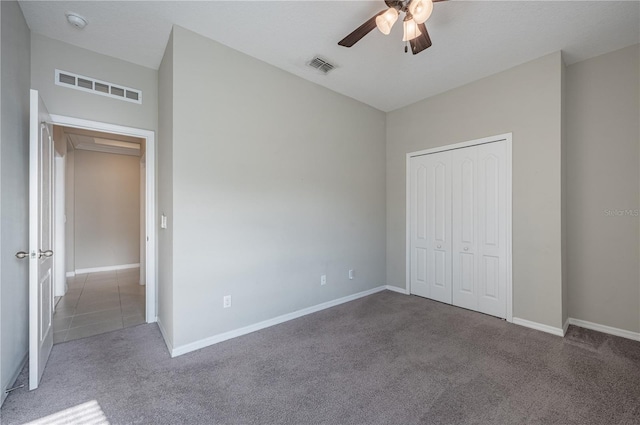 unfurnished bedroom featuring carpet, a closet, and ceiling fan