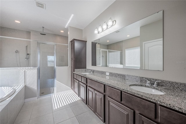 bathroom with tile patterned floors, vanity, and separate shower and tub