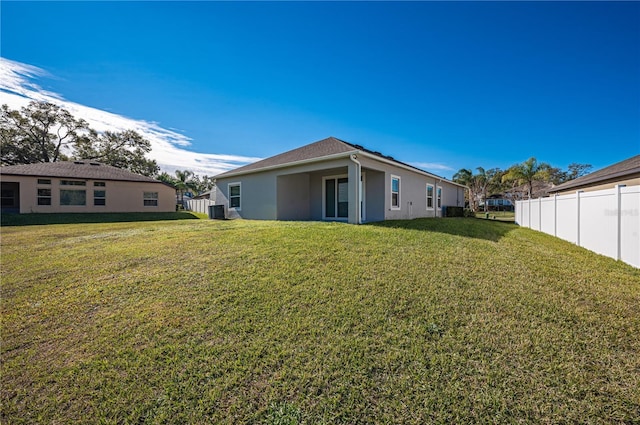 back of property featuring a yard