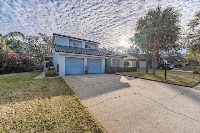 view of property with a garage and a front lawn