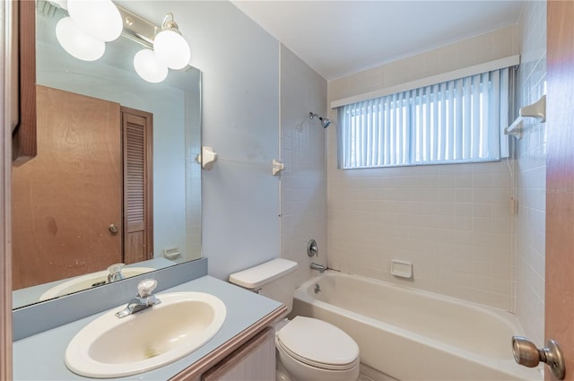 full bathroom featuring vanity, toilet, and tiled shower / bath combo