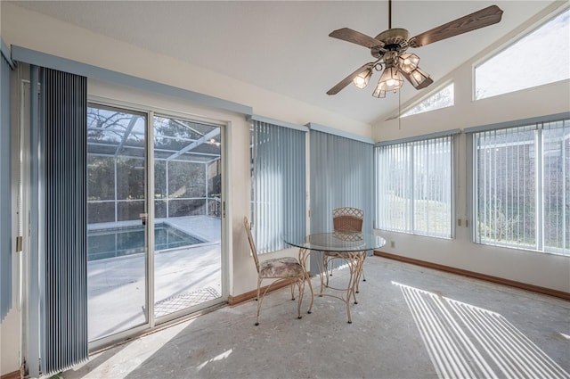 unfurnished sunroom with ceiling fan, a healthy amount of sunlight, and lofted ceiling