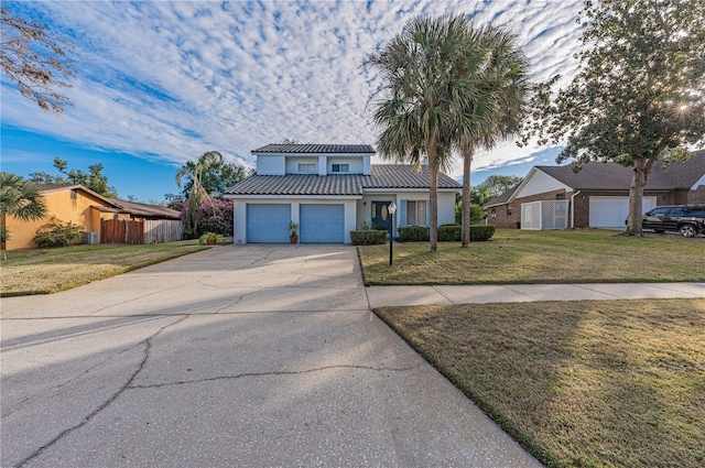 view of front of property with a garage and a front lawn