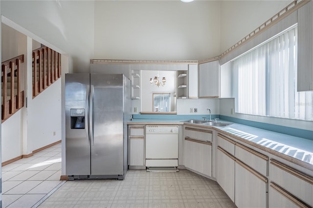 kitchen with dishwasher, stainless steel fridge, a notable chandelier, and sink