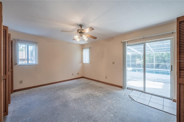 spare room with ceiling fan and a textured ceiling