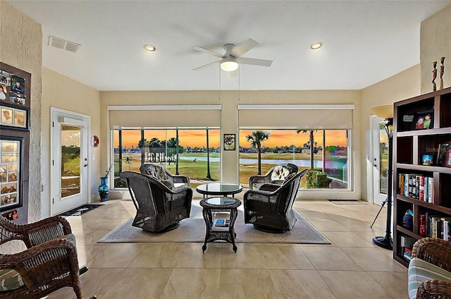 interior space with a wealth of natural light, ceiling fan, and light tile patterned floors