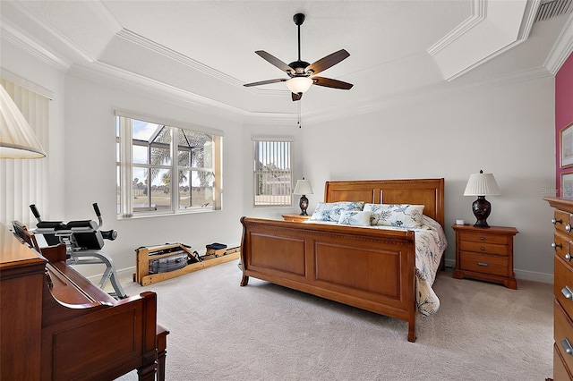 carpeted bedroom featuring a tray ceiling, ceiling fan, and ornamental molding