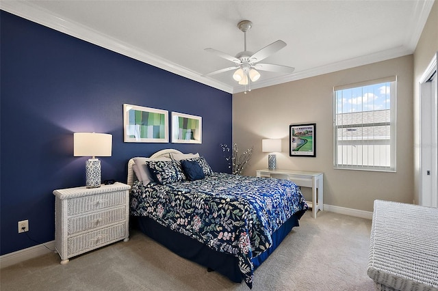 carpeted bedroom with ceiling fan and ornamental molding