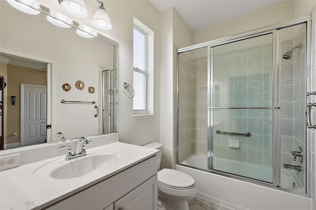 full bathroom featuring shower / bath combination with glass door, vanity, a healthy amount of sunlight, and toilet