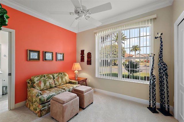 carpeted living room with ceiling fan and crown molding