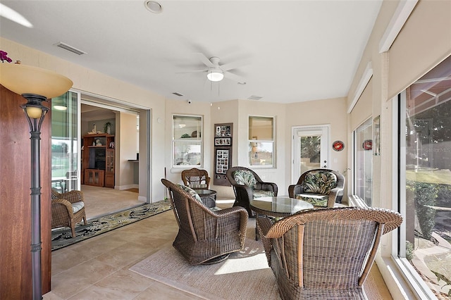 sunroom / solarium with a wealth of natural light and ceiling fan