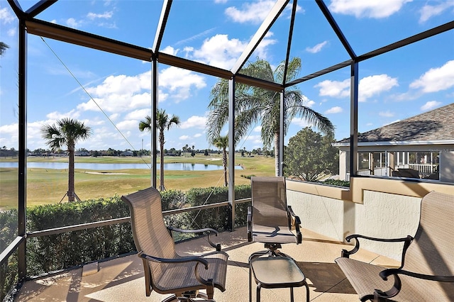 sunroom / solarium featuring a water view