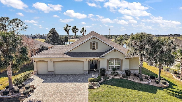 ranch-style home with a garage and a front lawn