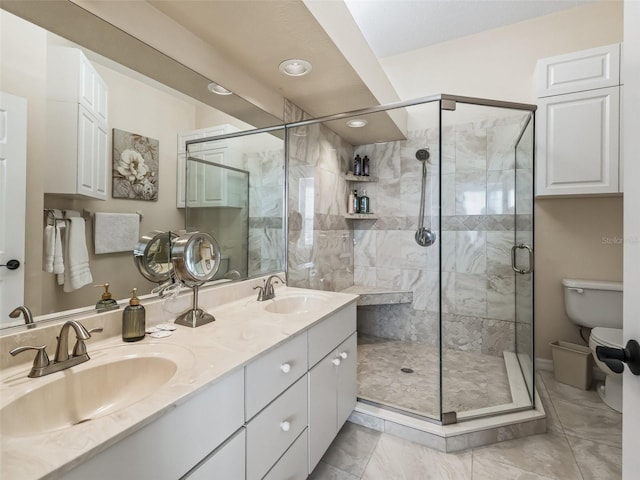 bathroom featuring a shower with door, vanity, and toilet