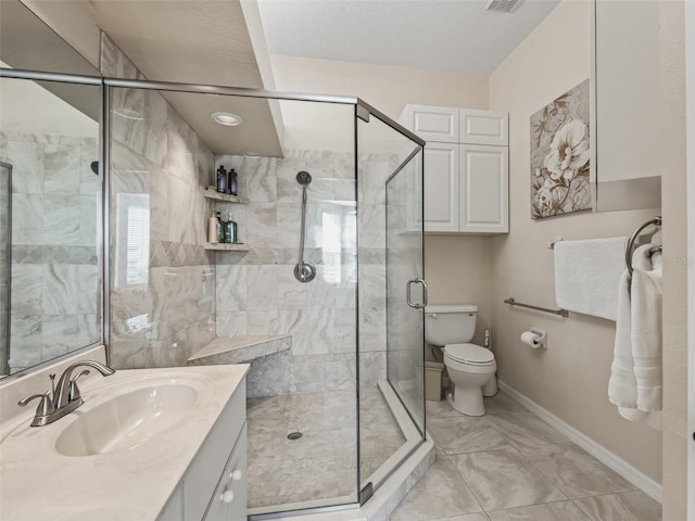 bathroom featuring a shower with door, vanity, and toilet