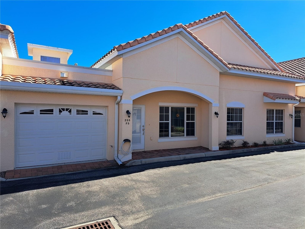 mediterranean / spanish-style house with a garage