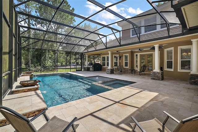 view of pool featuring ceiling fan, a patio area, a lanai, and an in ground hot tub