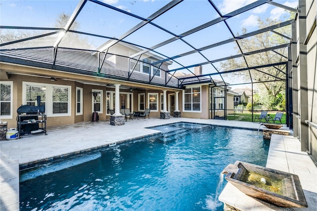 view of swimming pool with pool water feature, glass enclosure, ceiling fan, and a grill