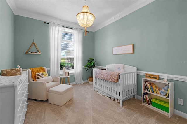 carpeted bedroom with a notable chandelier, a crib, and crown molding