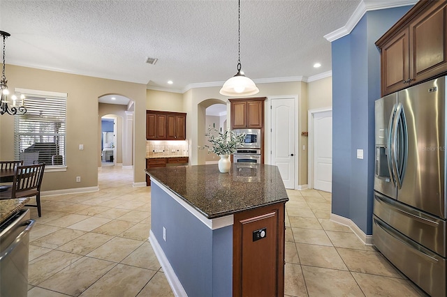 kitchen with a center island, light tile patterned floors, decorative light fixtures, stainless steel appliances, and a chandelier