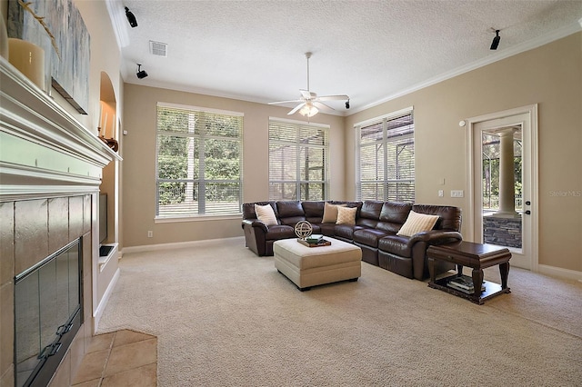 living room featuring ornate columns, ceiling fan, a textured ceiling, light carpet, and ornamental molding