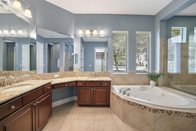 bathroom featuring tile patterned floors, tiled tub, and vanity