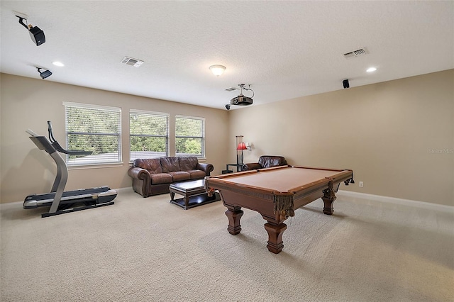 recreation room with light carpet, a textured ceiling, and pool table