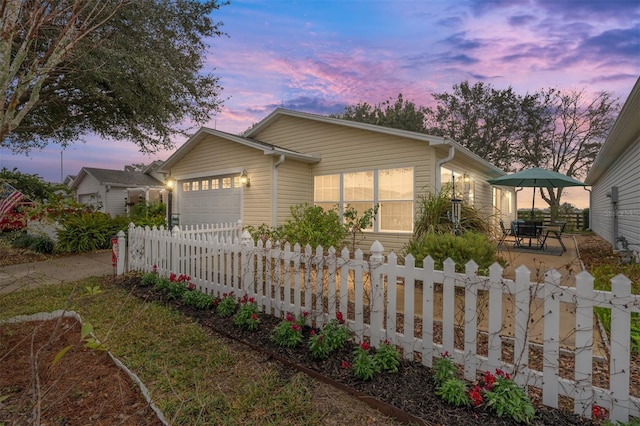 view of front of property featuring a garage and a patio area