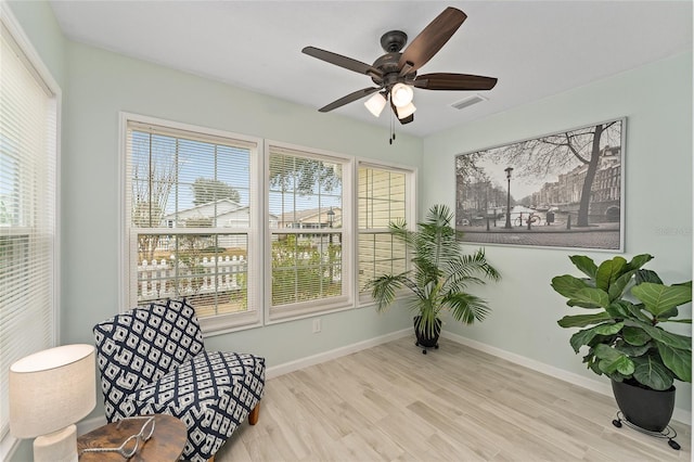 sitting room with ceiling fan, light hardwood / wood-style flooring, and a healthy amount of sunlight