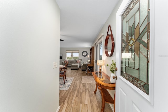 hallway with light hardwood / wood-style flooring