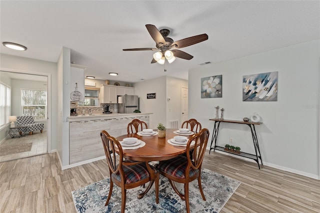 dining space featuring light hardwood / wood-style floors and ceiling fan