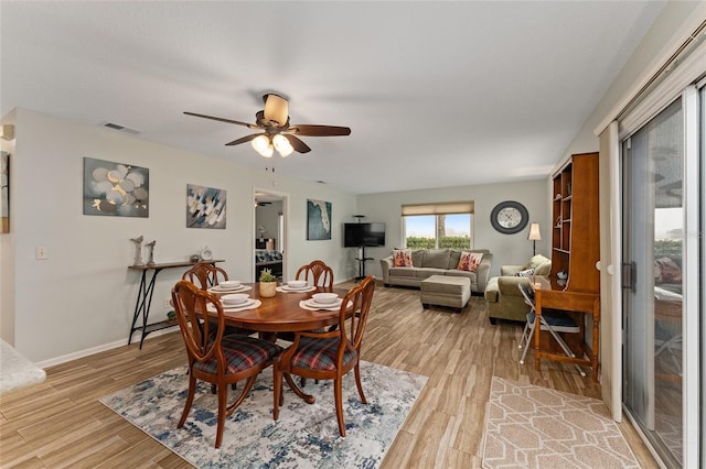 dining room with hardwood / wood-style flooring and ceiling fan