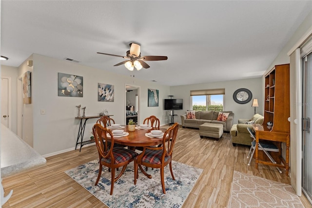 dining room featuring light hardwood / wood-style flooring and ceiling fan