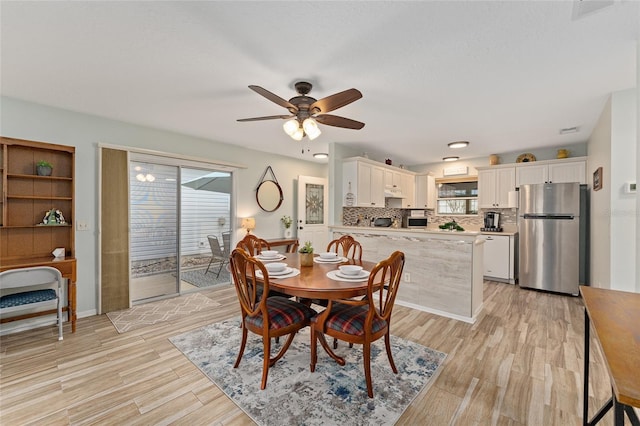 dining area featuring light hardwood / wood-style flooring and ceiling fan