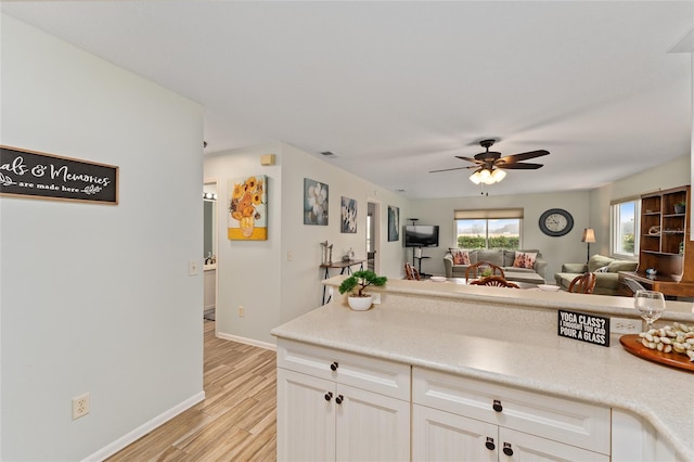 kitchen with white cabinetry, light hardwood / wood-style flooring, and ceiling fan