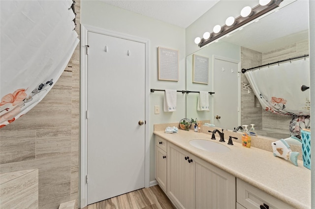 bathroom with vanity, hardwood / wood-style flooring, and a shower with curtain