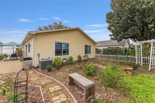 rear view of house with a patio area and central air condition unit