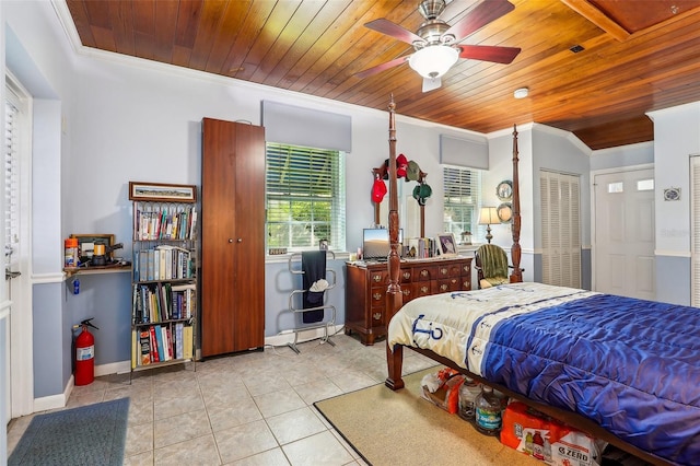 bedroom with light tile patterned floors, ceiling fan, crown molding, and wood ceiling