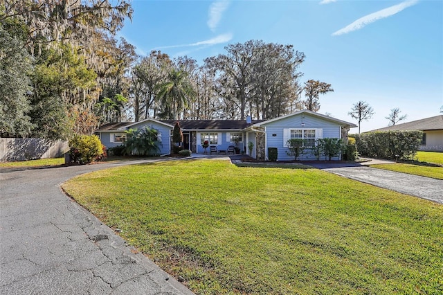 ranch-style home featuring a front yard