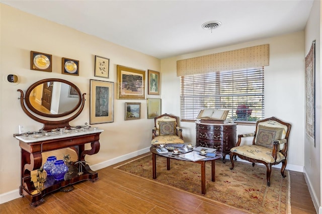 sitting room with wood-type flooring