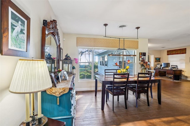 dining space with dark hardwood / wood-style floors