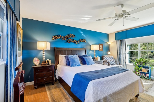 bedroom with ceiling fan and dark wood-type flooring