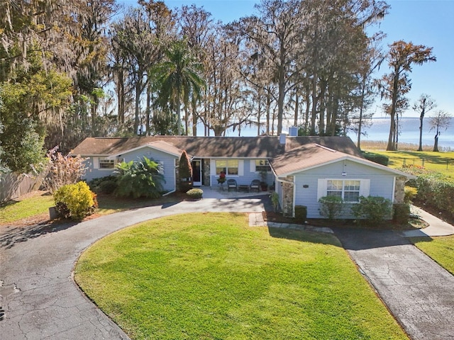 ranch-style home featuring a front yard and a water view